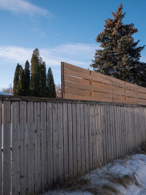 Neutral privacy fence in a landscaped yard